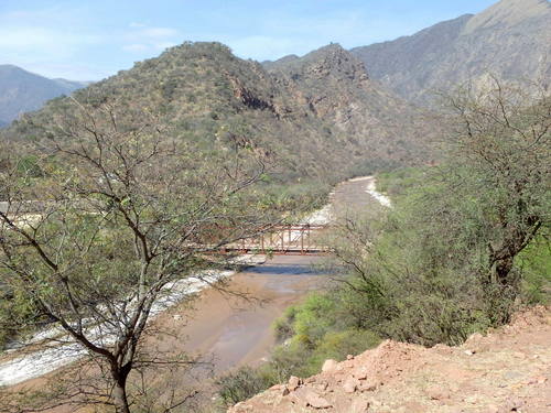A single vehicle bridge to access El Guayacan across the Rio Guachipas.